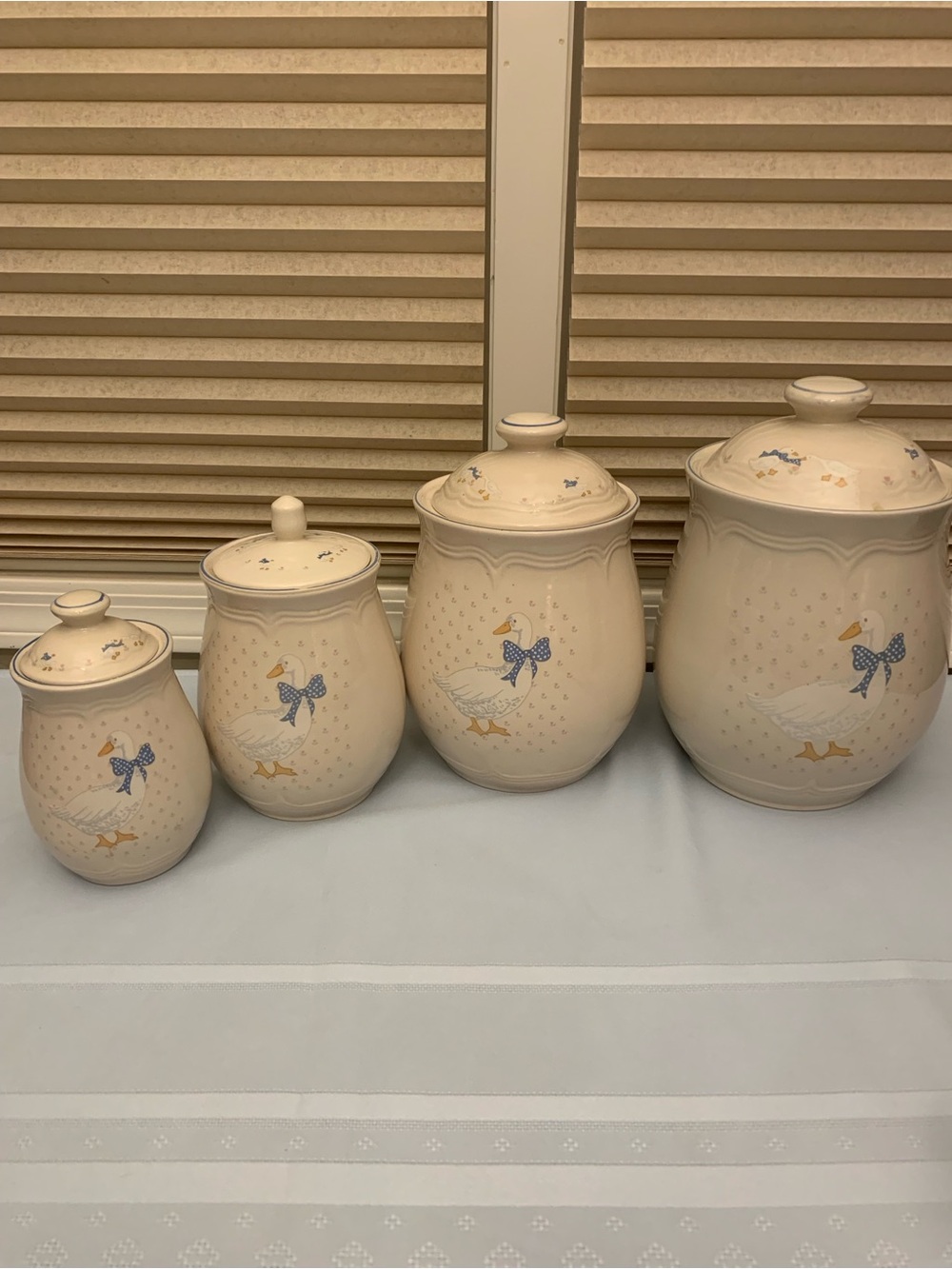 Vintage Four-Piece Stonewear Goose Canister Set with Blue Bow Accents